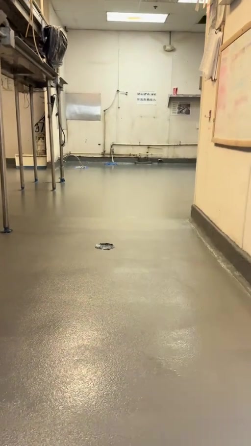 Finished commercial kitchen floor with stainless steel work tables