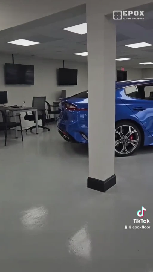 Blue car and finished gray floor in an EpoX automotive dealership project