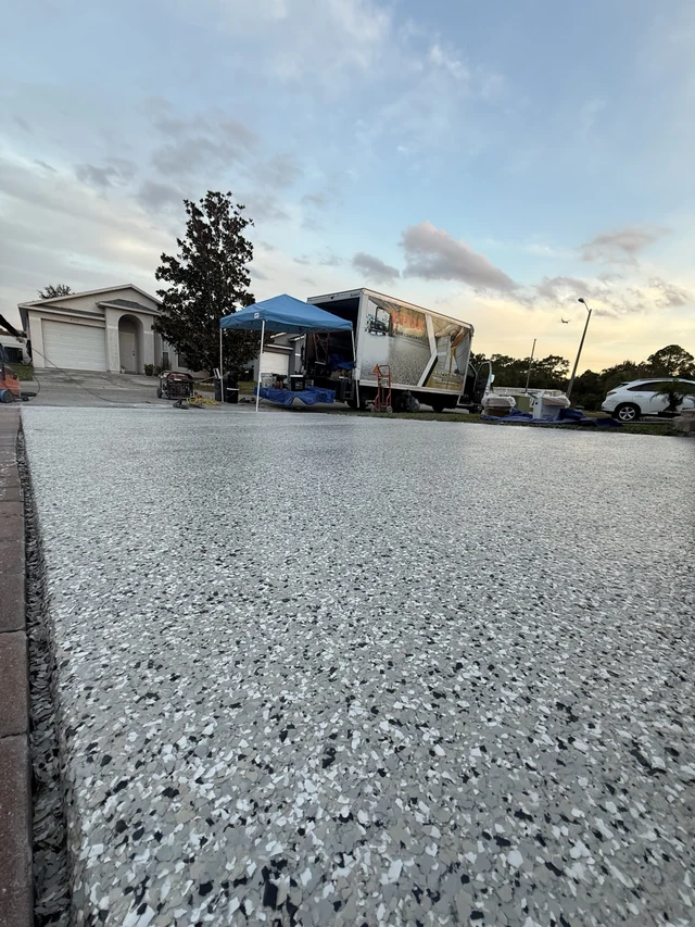 Close view of a real decorative flake driveway with the EpoX work truck in the background