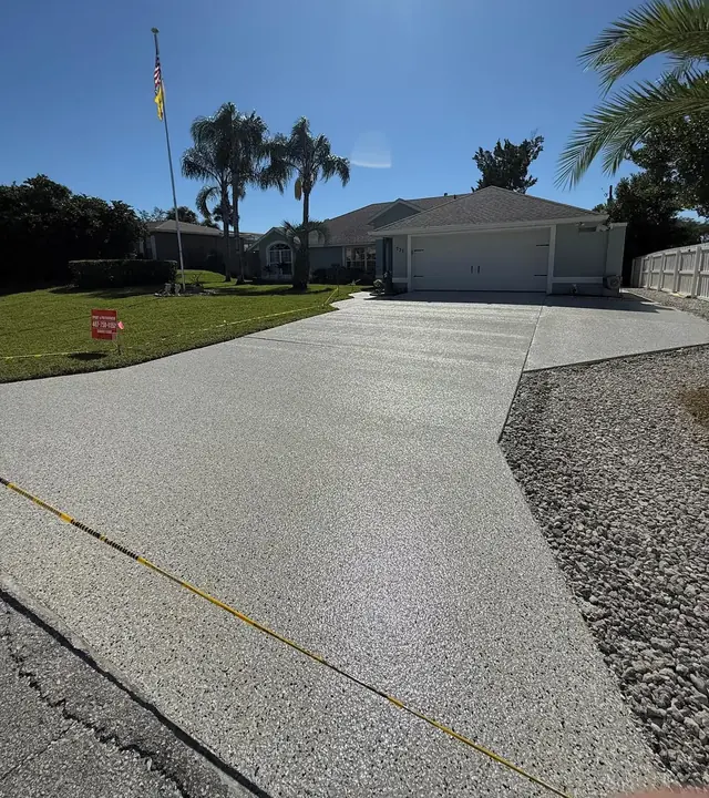 Complete decorative driveway in front of a home with palm trees by EpoX Floor Coatings