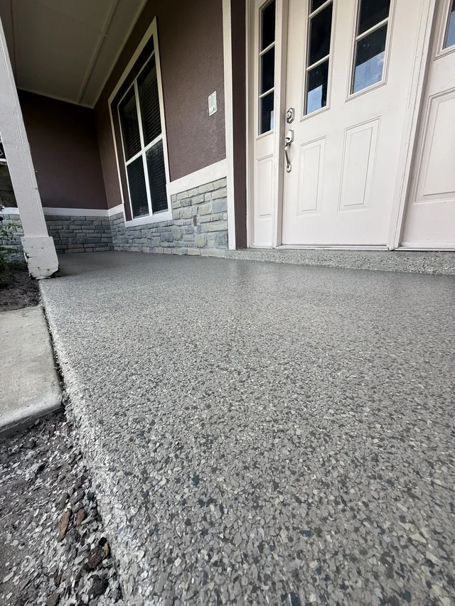 Front porch with a white entrance door and a real EpoX decorative full-flake floor
