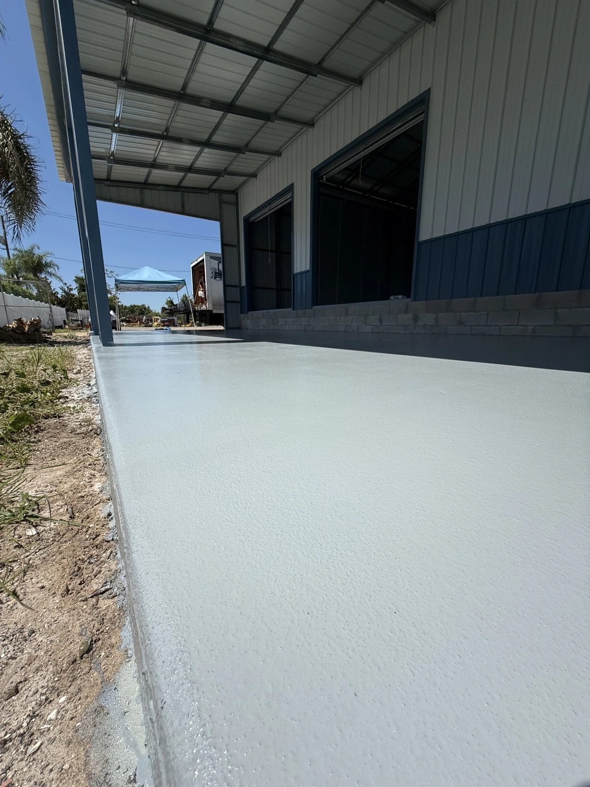 Finished medium-gray floor in the covered front area of the Haines City warehouse