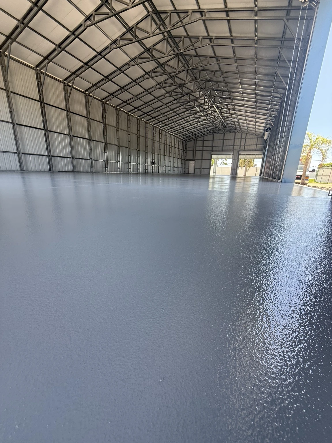Wide perspective of the Haines City warehouse and completed medium-gray floor