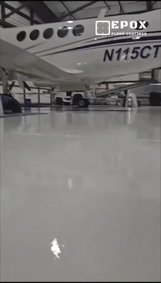 Video preview showing the white aircraft and reflective finished hangar floor