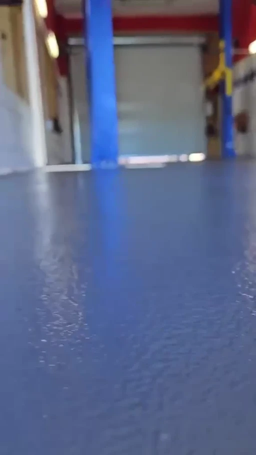 Finished EpoX floor beside vehicle lifts in an automotive service workshop